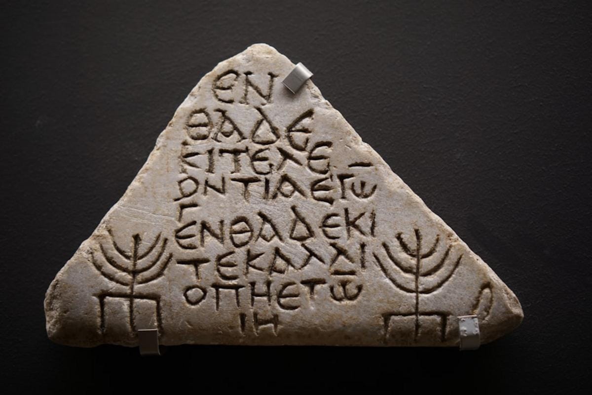 Close-up of ancient Neolithic tools and artifacts with detailed craftsmanship, displayed in a museum setting highlighting their historical significance.