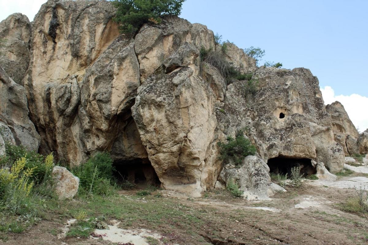 A detailed archaeological site of Neolithic settlements in Turkey, showcasing ancient houses and tools.