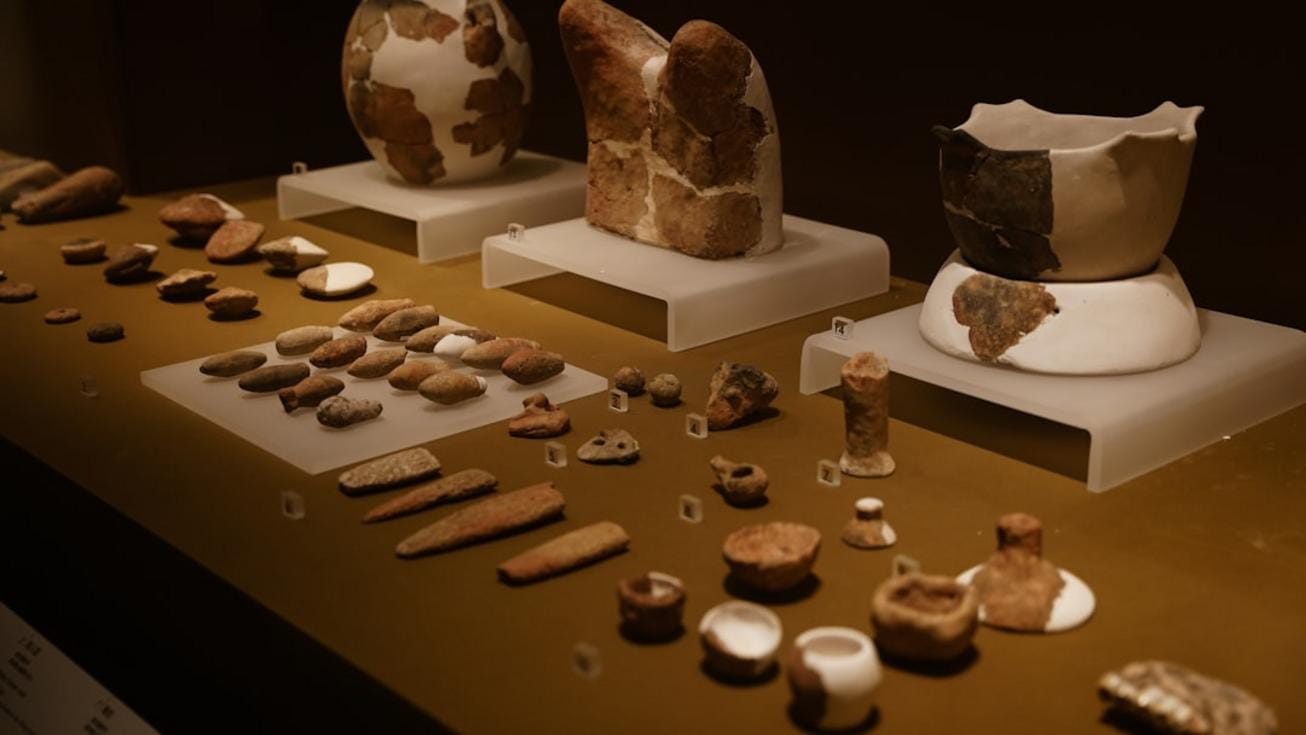 Image of Neolithic village reconstruction with artifacts and tools displayed for educational purposes