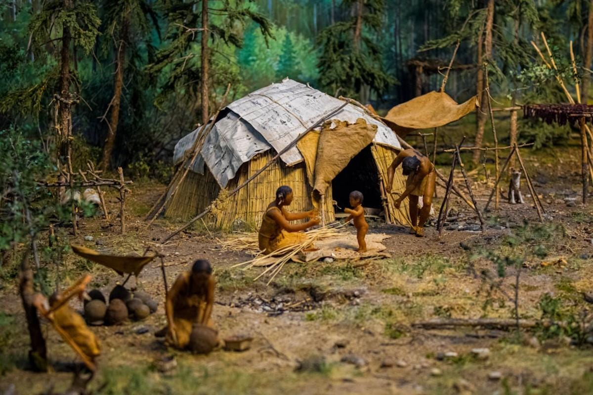 A reconstruction of Neolithic life at the Taş Tepeler site, showing early inhabitants, tools, and structures in a detailed archaeological setting.