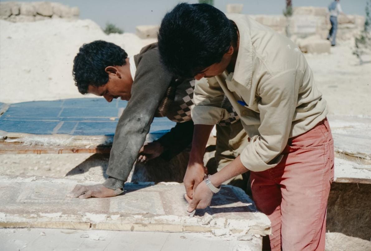 Photograph of archaeologists excavating artifacts at the Taş Tepeler site, showcasing tools, pottery shards, and early settlements uncovered during ongoing digs.